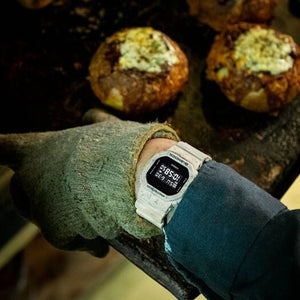 Casio G-Shock DW-5600WM-5DR worn on wrist in a bakery kitchen setting