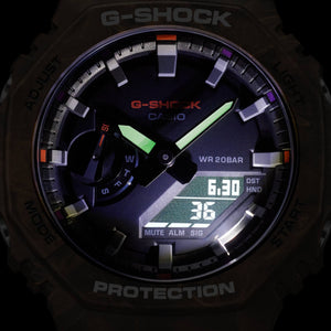 Casio G-Shock GA-2100FR-5AER dial illuminated in low light showing backlit hands