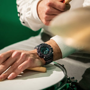 Casio G-Shock GA-2200SKL-8AER watch worn on wrist while playing drums, lifestyle shot