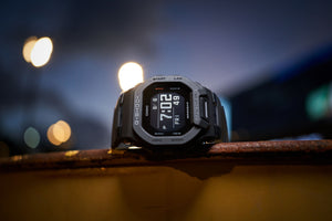 Casio G-Shock GBD-200-1DR watch at night with city bokeh lights in background, lifestyle shot