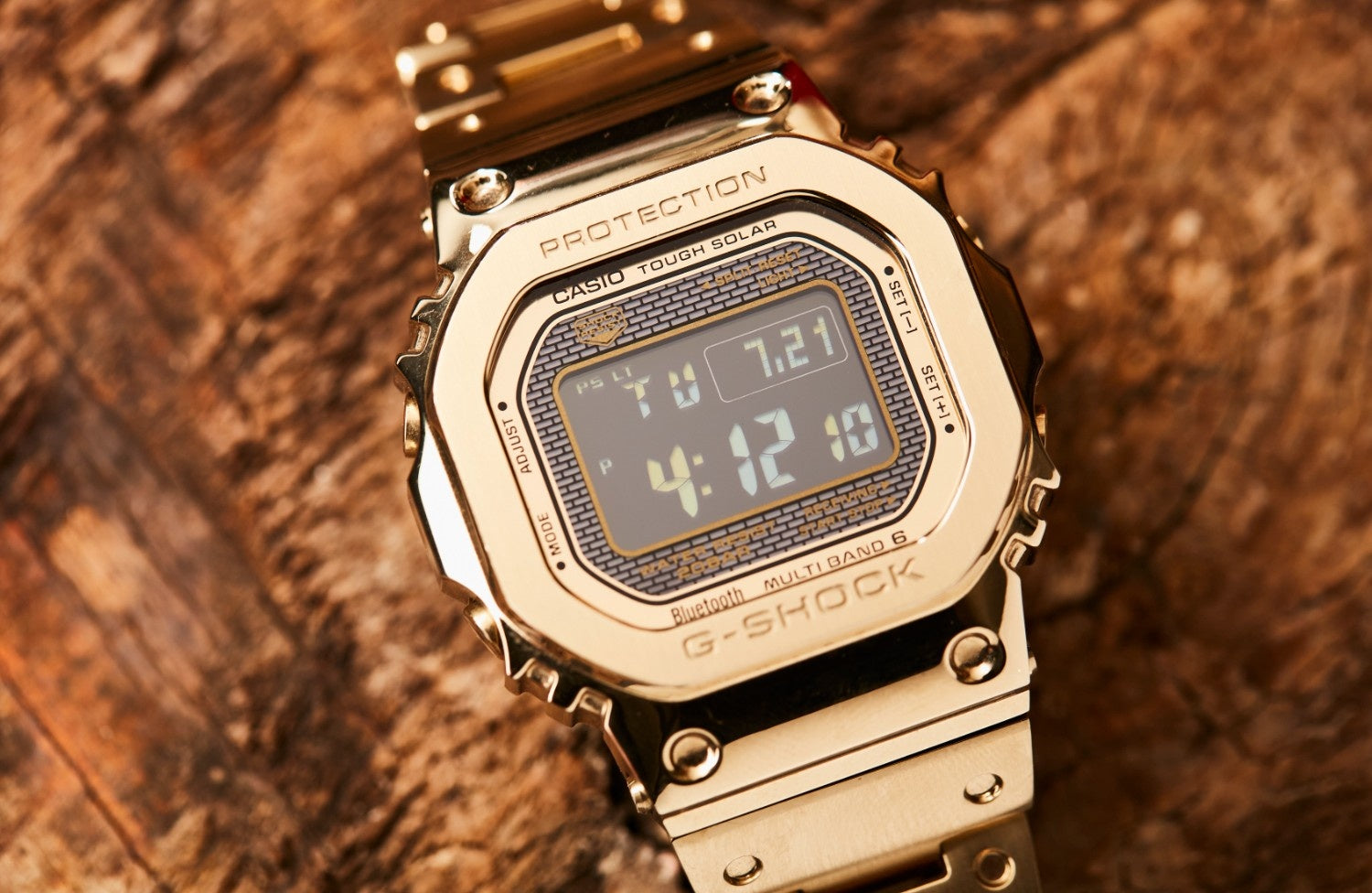 Casio G-Shock GMW-B5000GD-9DR Gold Stainless Steel Wristwatch Product shot with rock background 