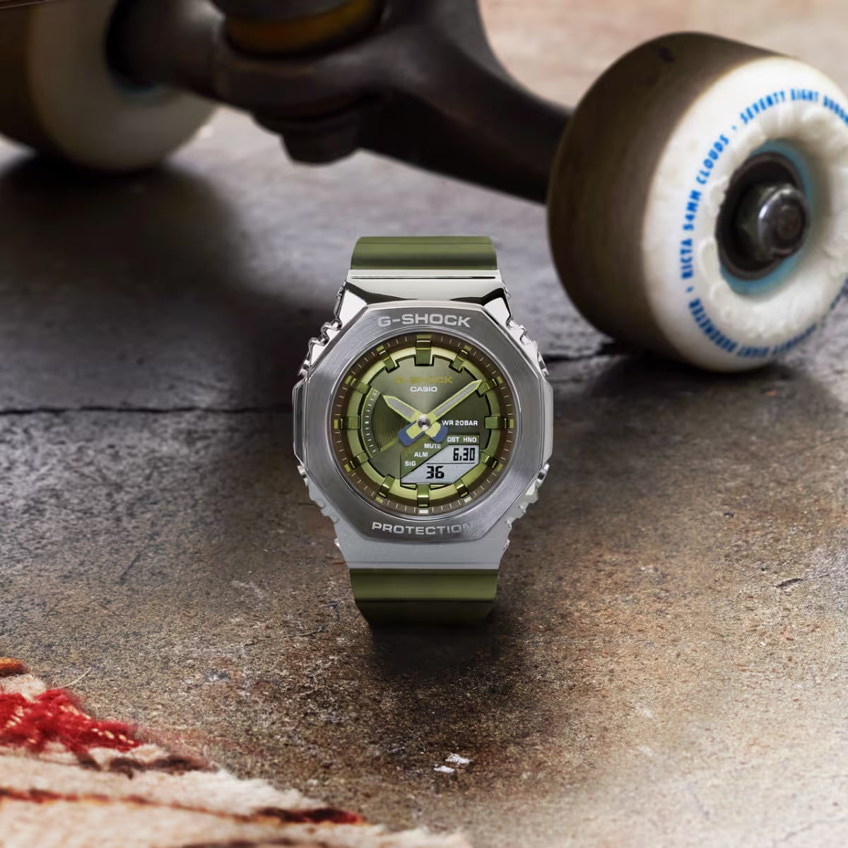 Casio G-Shock GM-S2100-3ADR Stainless Steel Case Wristwatch Product Shot with skateboard background 