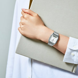 Casio AQ-230A-7DMQYES watch worn on wrist while holding a notebook, lifestyle shot