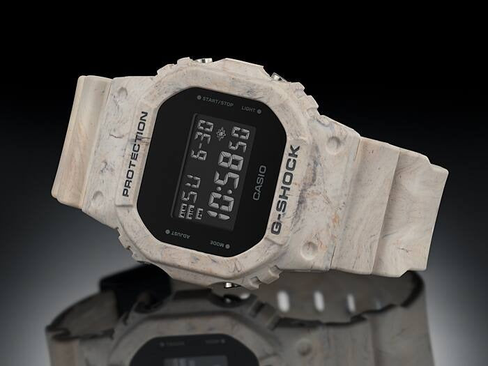 Casio G-Shock DW-5600WM-5DR marbled resin watch, angled view on black reflective background