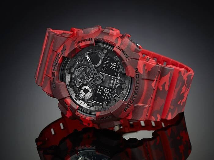 Casio G-Shock GA-100CM-4AER angled view on dark reflective background