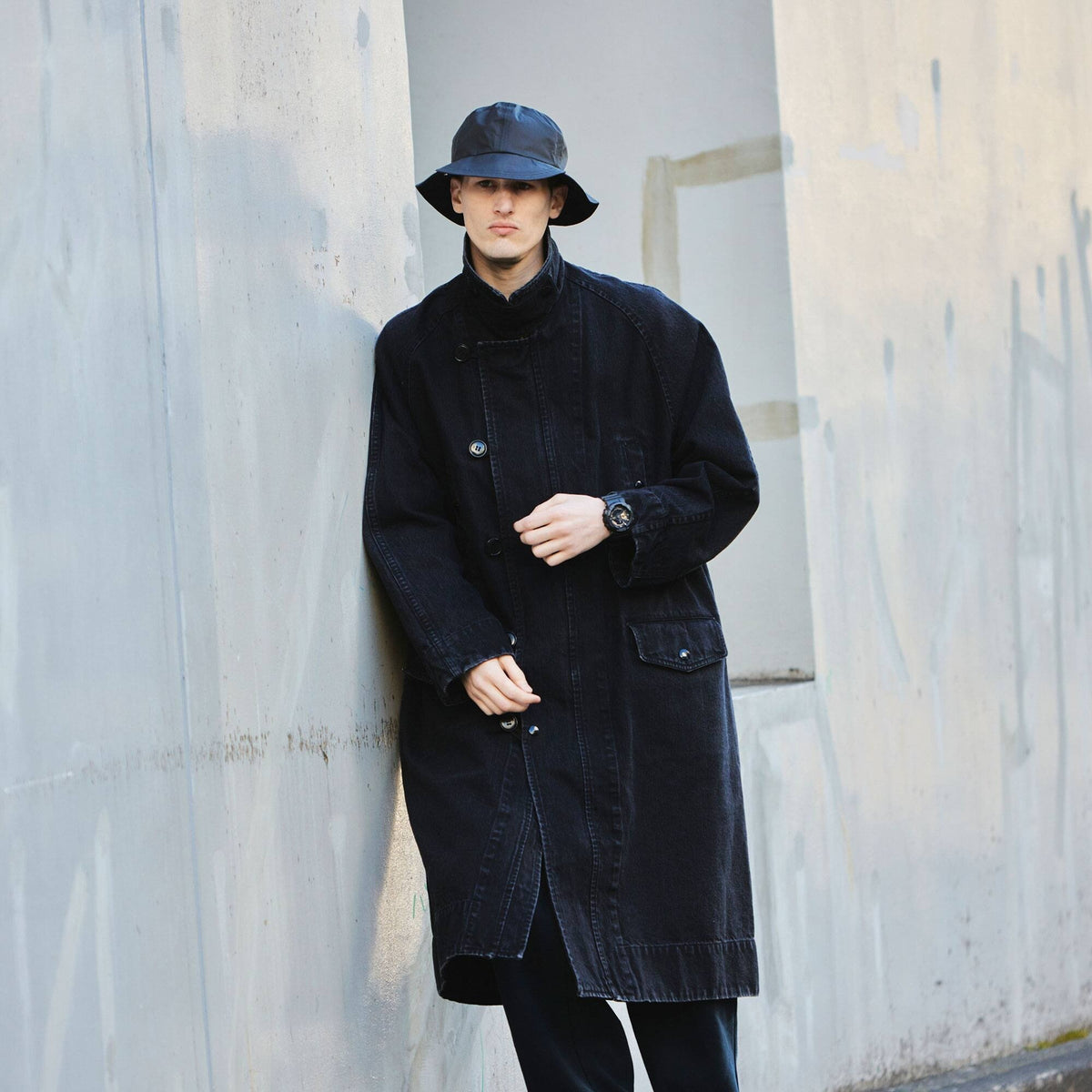 Casio G-Shock GA-110RG-1AER watch worn on wrist, street style lifestyle shot with model in bucket hat