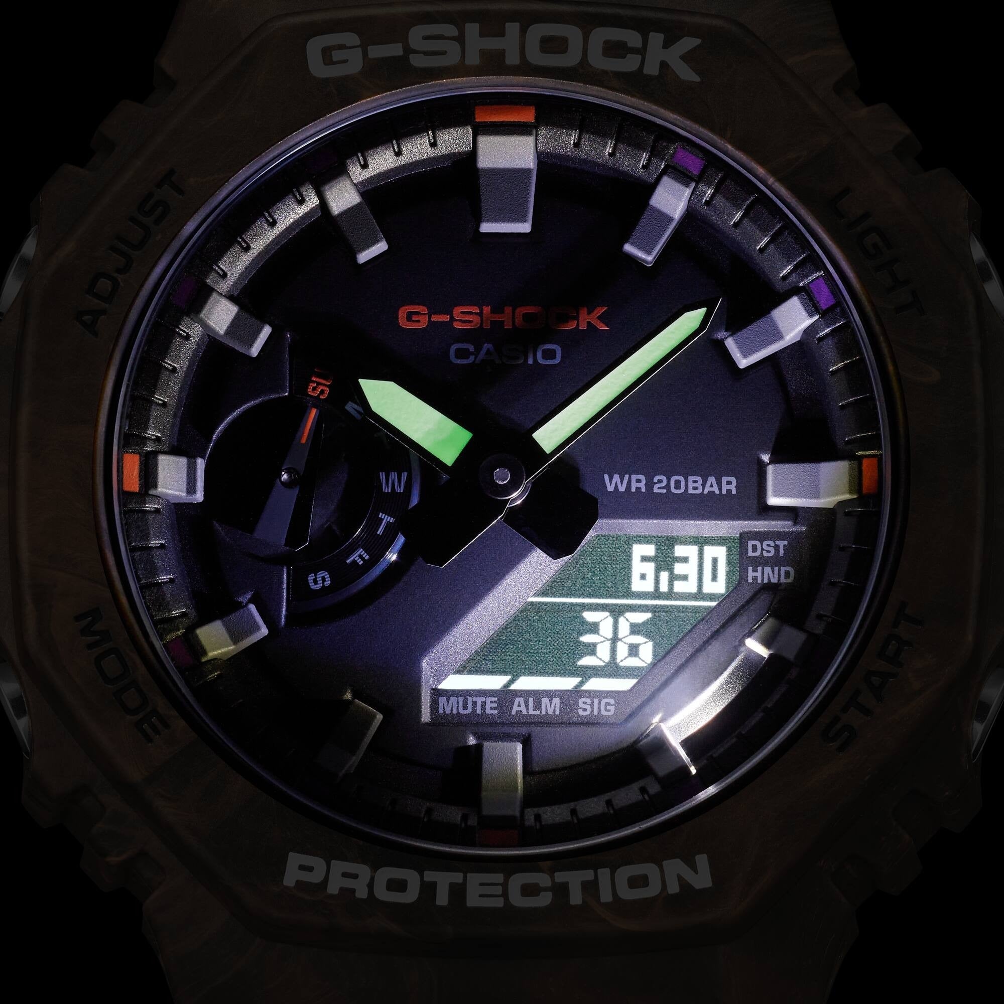 Casio G-Shock GA-2100FR-5AER dial illuminated in low light showing backlit hands